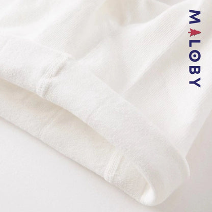 Collants fins blancs à motif pompons pour fille, parfaits pour les occasions spéciales.