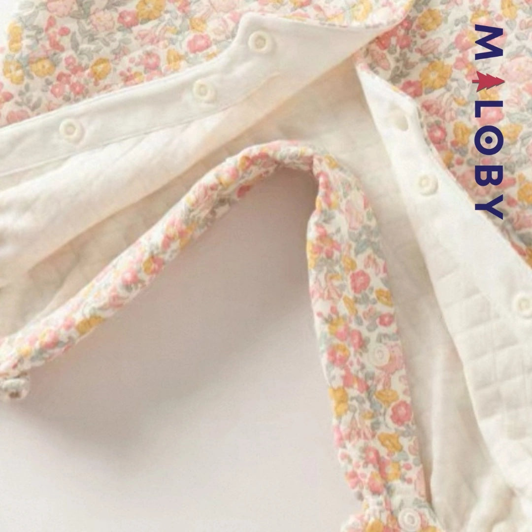 Combinaison habillée motif floral pour bébé fille en rose, idéale pour les anniversaires.